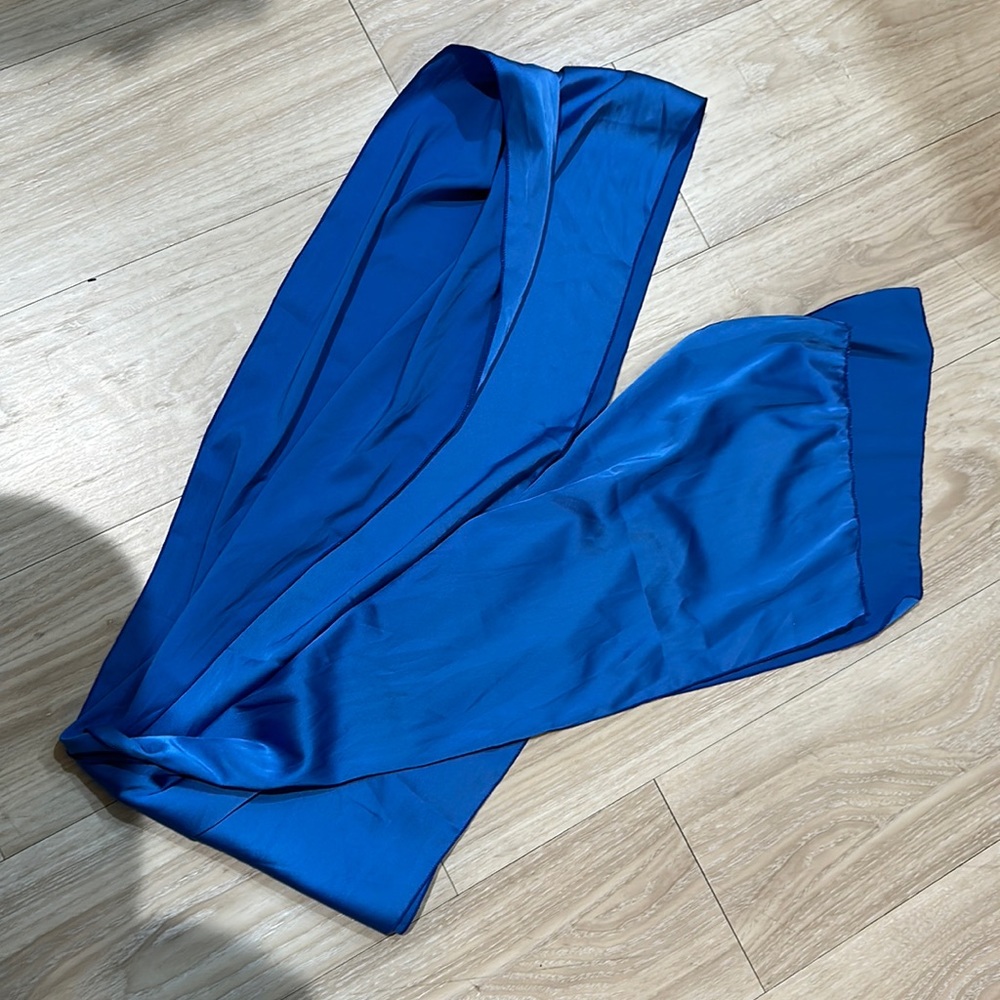 NWOT satin fabric to be tied as a shirt. Can be worn many ways!